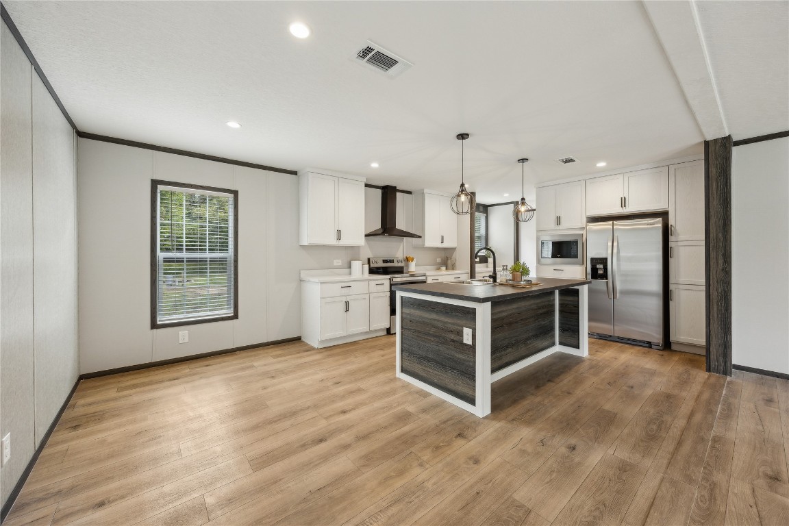 85128 Angie Road Yulee, FL 32097 - Photo 8 of 14 a kitchen with stainless steel appliances a stove top oven and a refrigerator