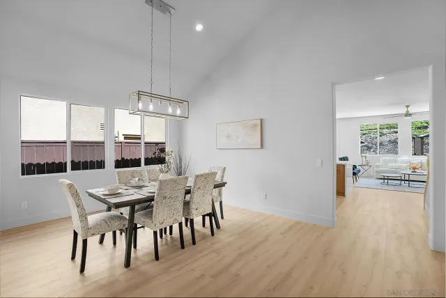 a bedroom with a large bed and wooden floor