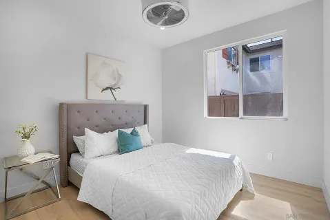 a large white kitchen with a sink a stove and a window