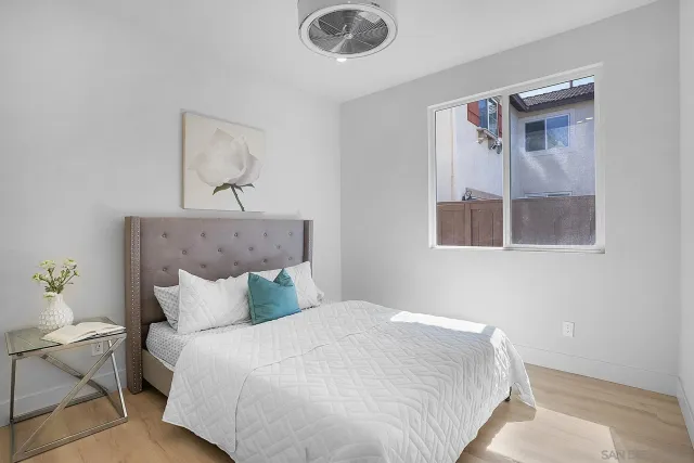 a large white kitchen with a sink a stove and a window