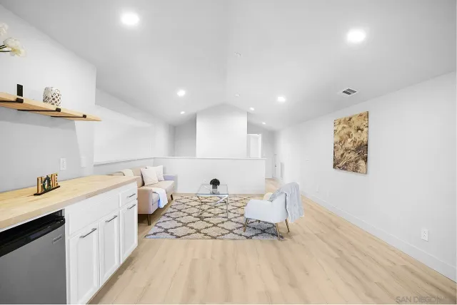 a living room with furniture and white walls