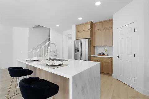a living room with furniture and a large window with wooden floor