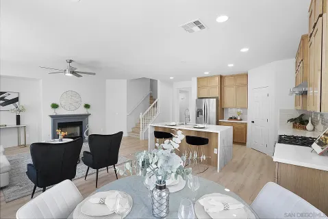 a kitchen with sink cabinets and dining table