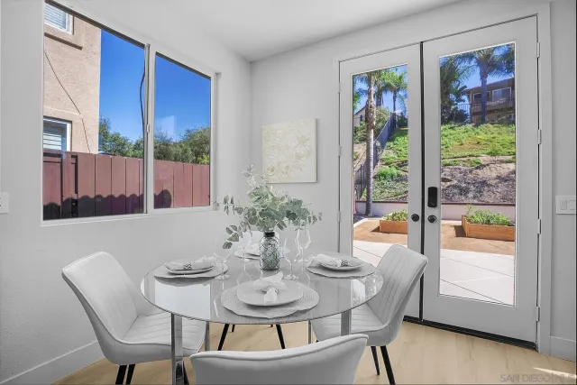 a living room with furniture kitchen view and a chandelier