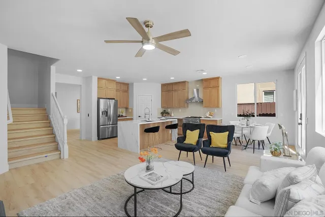 a kitchen with granite countertop white cabinets a dining table and chairs