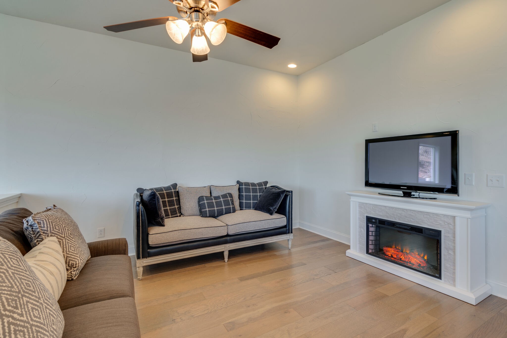 609 Floating Mill Village Road Silver Point, TN 38582 - Photo 14 of 64 a living room with furniture a flat screen tv and a fireplace