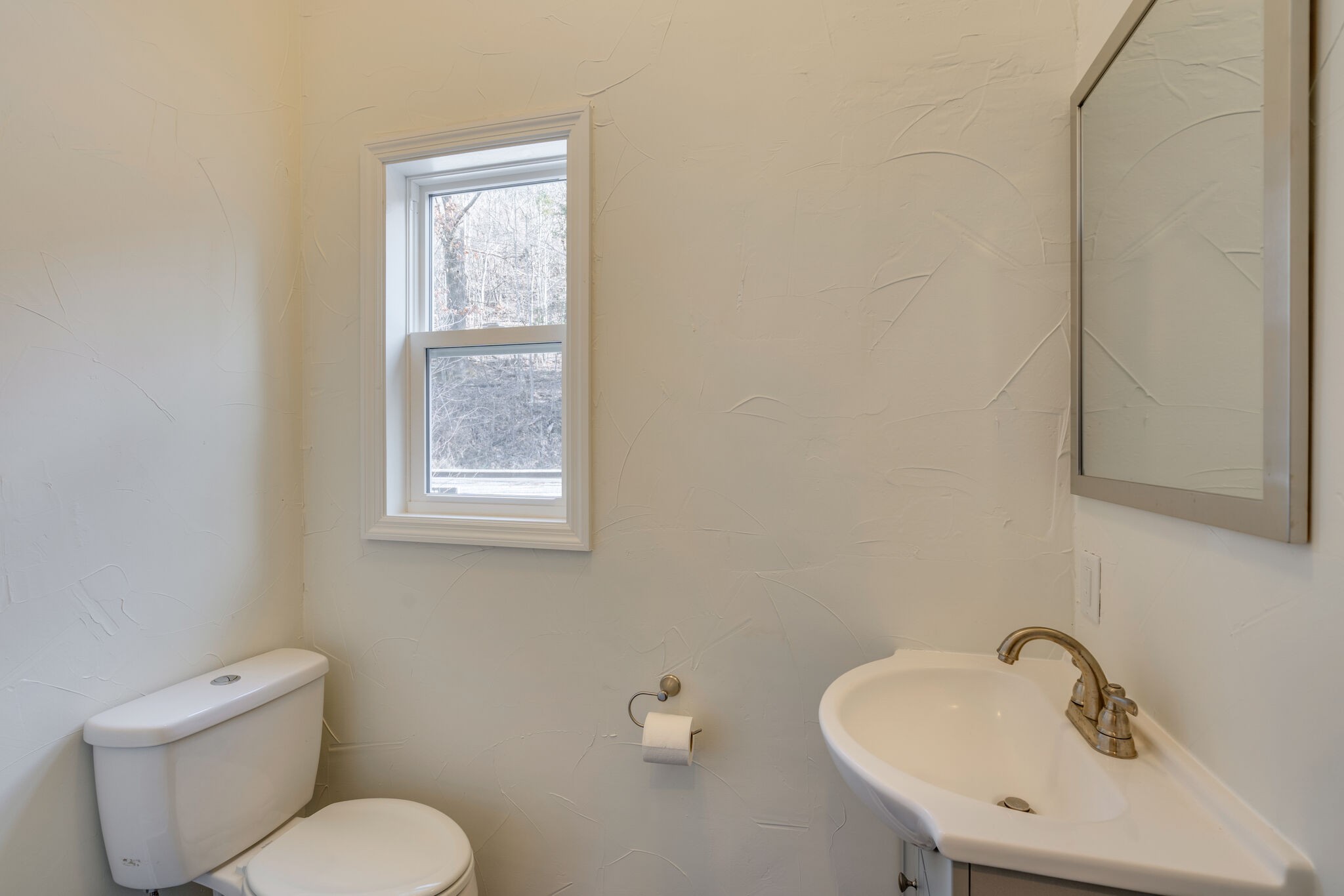 609 Floating Mill Village Road Silver Point, TN 38582 - Photo 15 of 64 a bathroom with a toilet sink and mirror