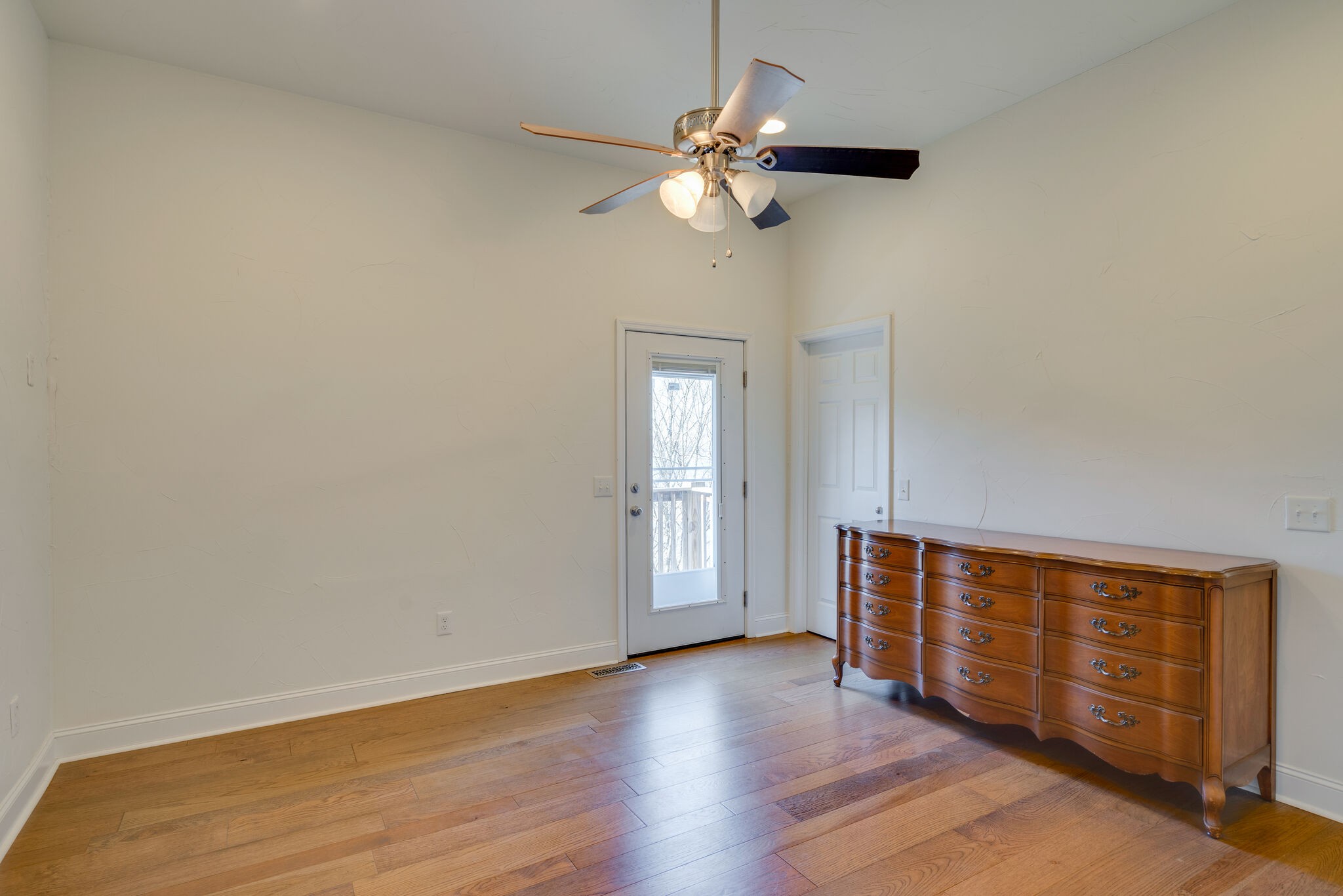 609 Floating Mill Village Road Silver Point, TN 38582 - Photo 17 of 64 a view of an empty room with wooden floor and fan
