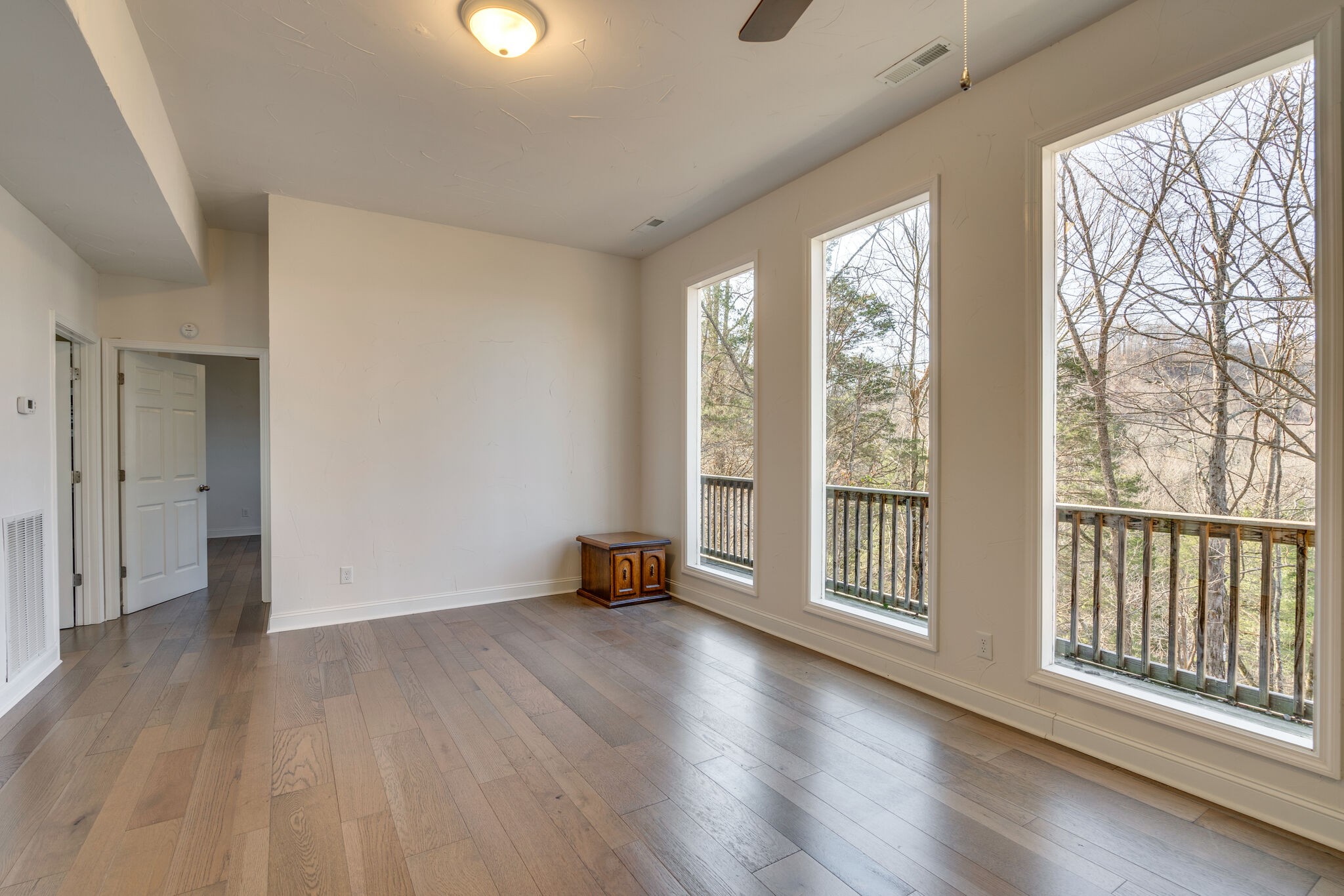 609 Floating Mill Village Road Silver Point, TN 38582 - Photo 25 of 64 a view of an empty room with wooden floor and a window