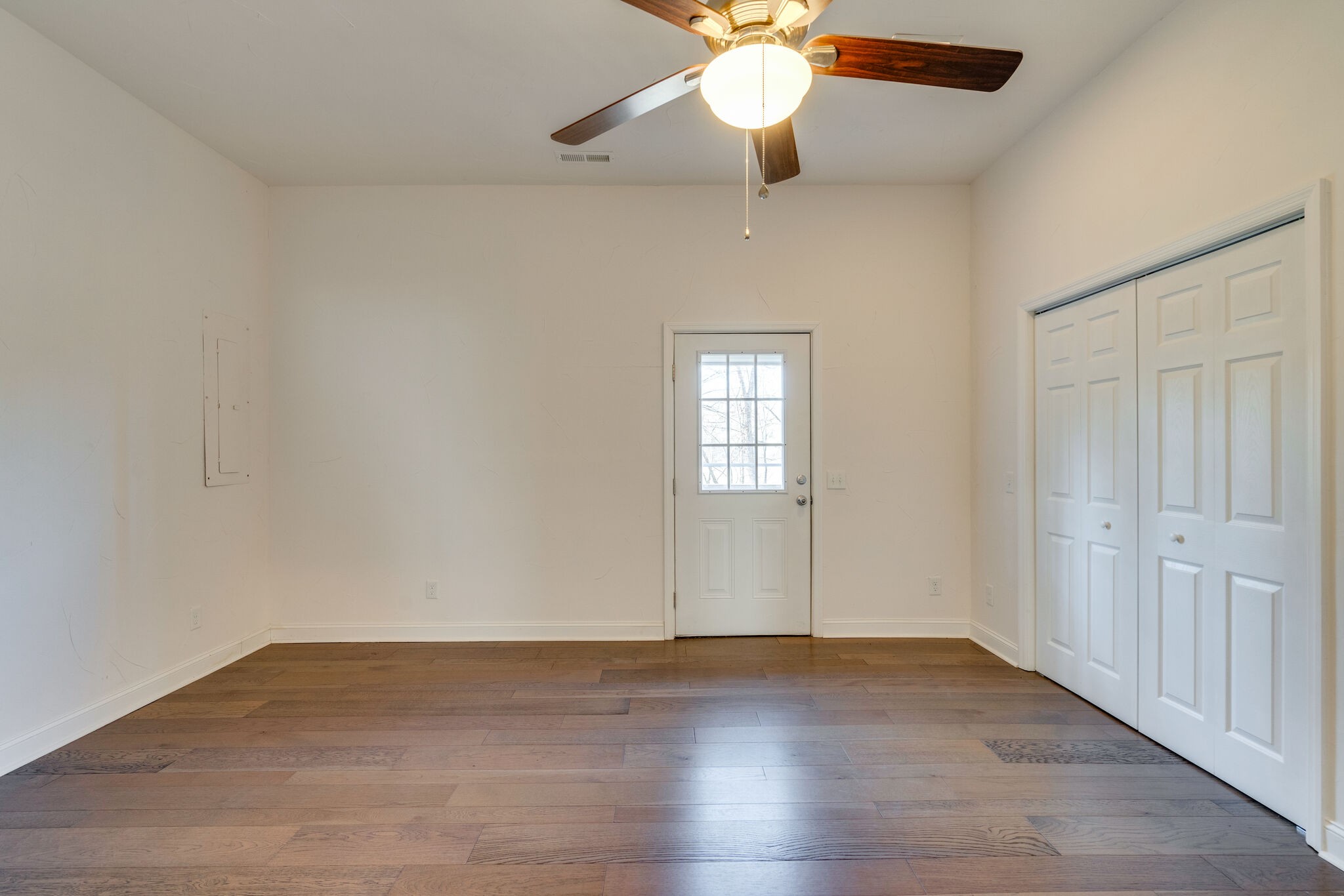 609 Floating Mill Village Road Silver Point, TN 38582 - Photo 30 of 64 an empty room with wooden floor chandelier fan and windows
