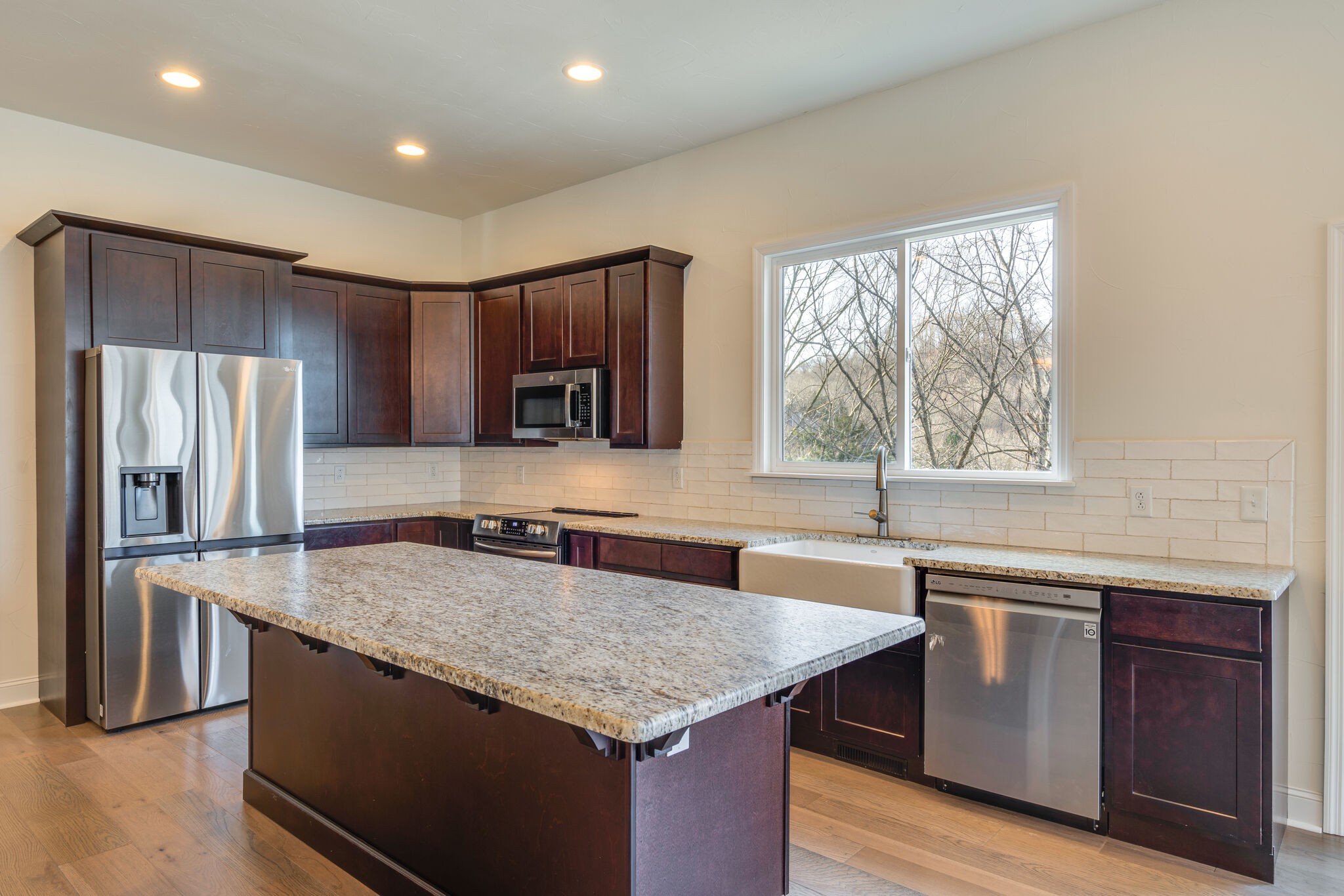 609 Floating Mill Village Road Silver Point, TN 38582 - Photo 7 of 64 a kitchen with stainless steel appliances granite countertop a sink and a refrigerator