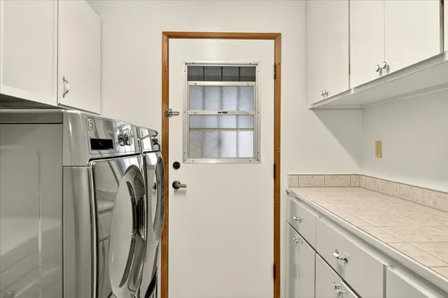 a view of a kitchen with a sink and refrigerator