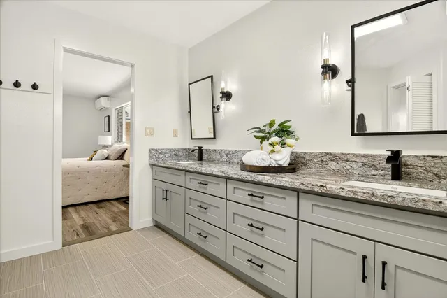 a spacious bathroom with double sink and a mirror