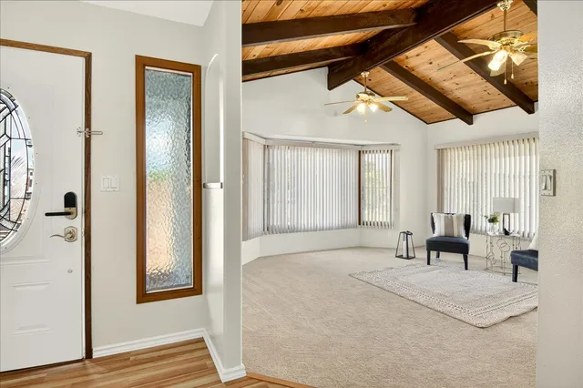 a living room with furniture and large windows