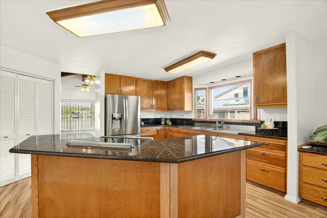 a kitchen with stainless steel appliances granite countertop a sink a stove counter space and cabinets