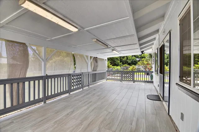 a view of a porch with wooden floor and outdoor space