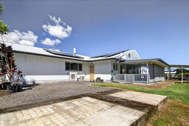 a front view of a house with a yard and entertaining space