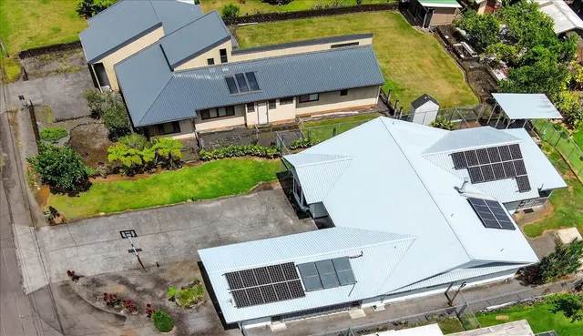 an aerial view of a house with a yard