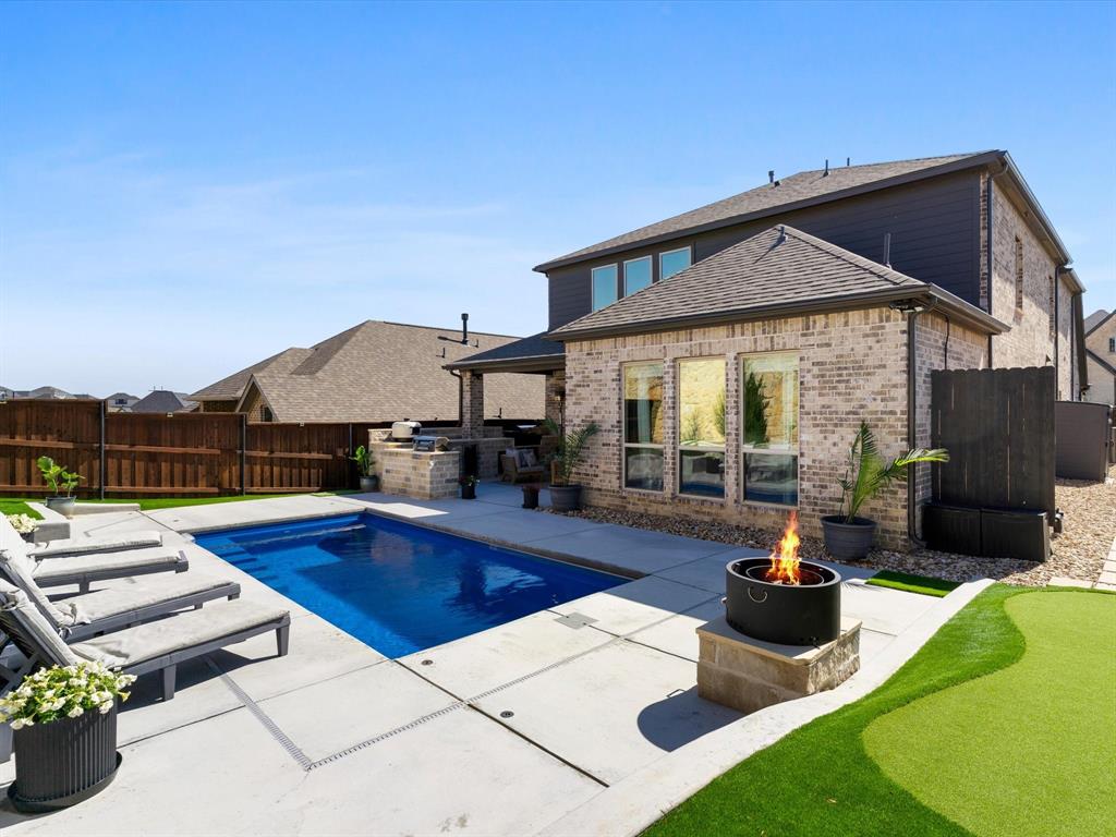 112 Pecan Court Rhome, TX 76078 - Photo 1 of 38 Resort-style backyard featuring a stunning sparkling swimming pool, creating the perfect outdoor retreat at this beautiful home in Rhome, Texas.