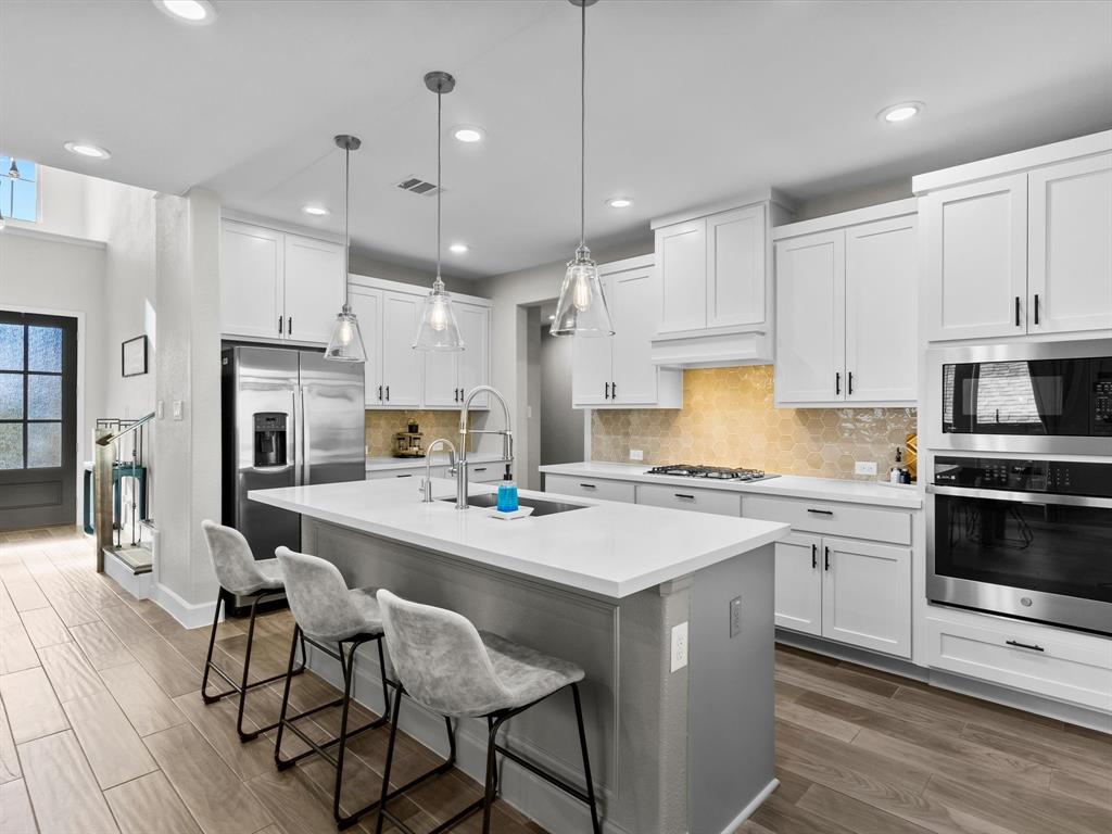 112 Pecan Court Rhome, TX 76078 - Photo 8 of 38 Modern kitchen with ample counter space, cabinetry, and a functional layout ideal for everyday living and entertaining in this Rhome home.
