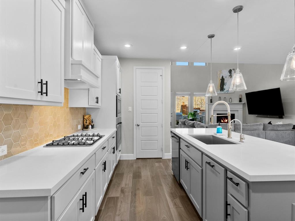 112 Pecan Court Rhome, TX 76078 - Photo 10 of 38 Large kitchen island perfect for meal prep, casual dining, or gathering with family and friends.