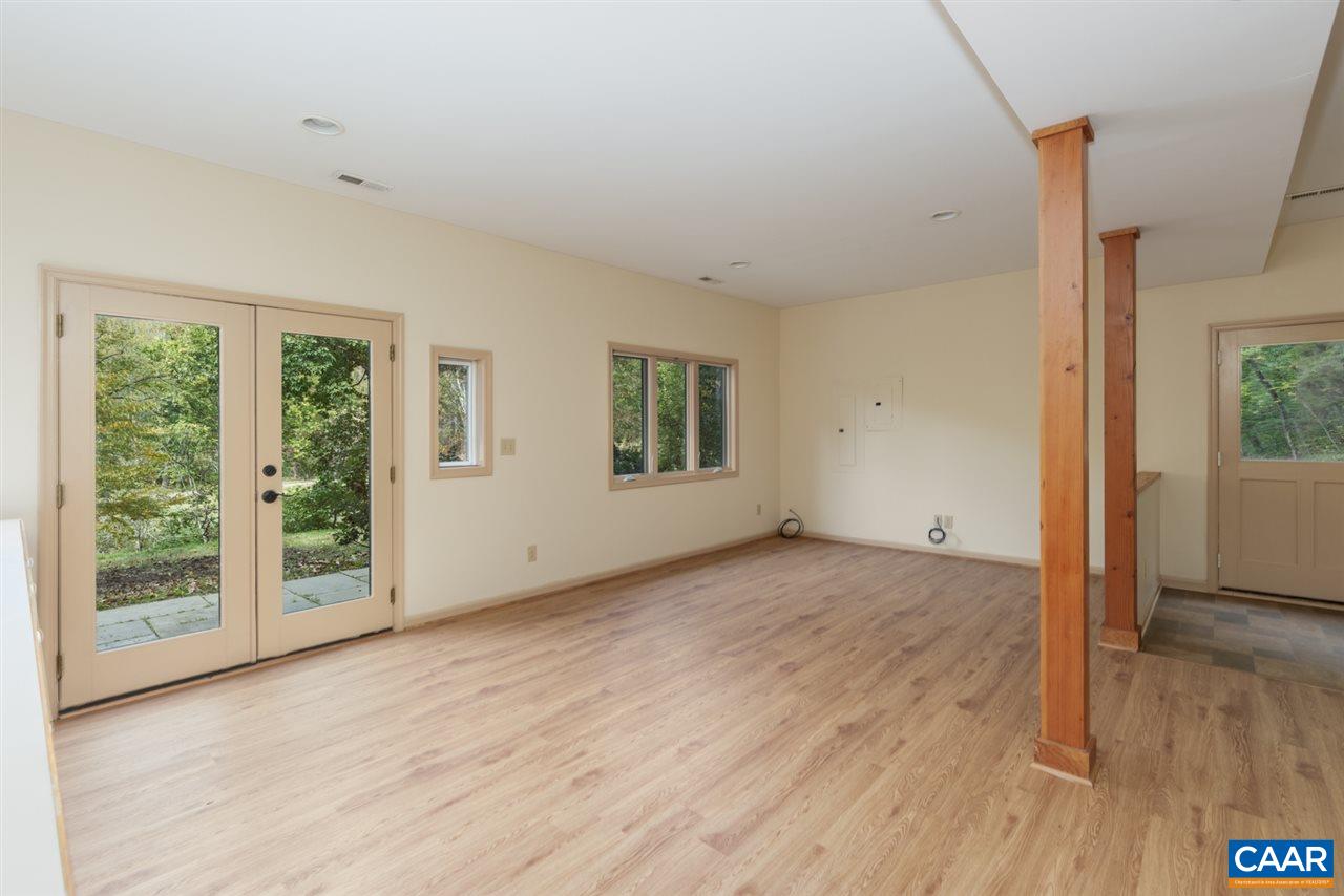 4365 Taylor Creek Road Afton, VA 22920 - Photo 28 of 49 a view of an empty room with wooden floor and a window