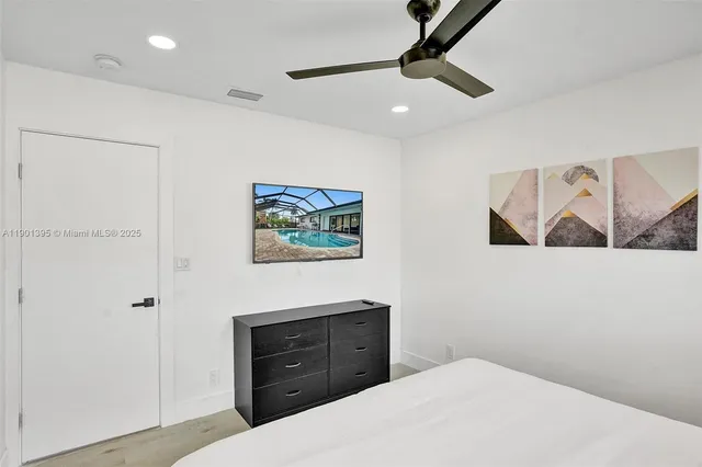 a view of a chair and table in backyard of the house