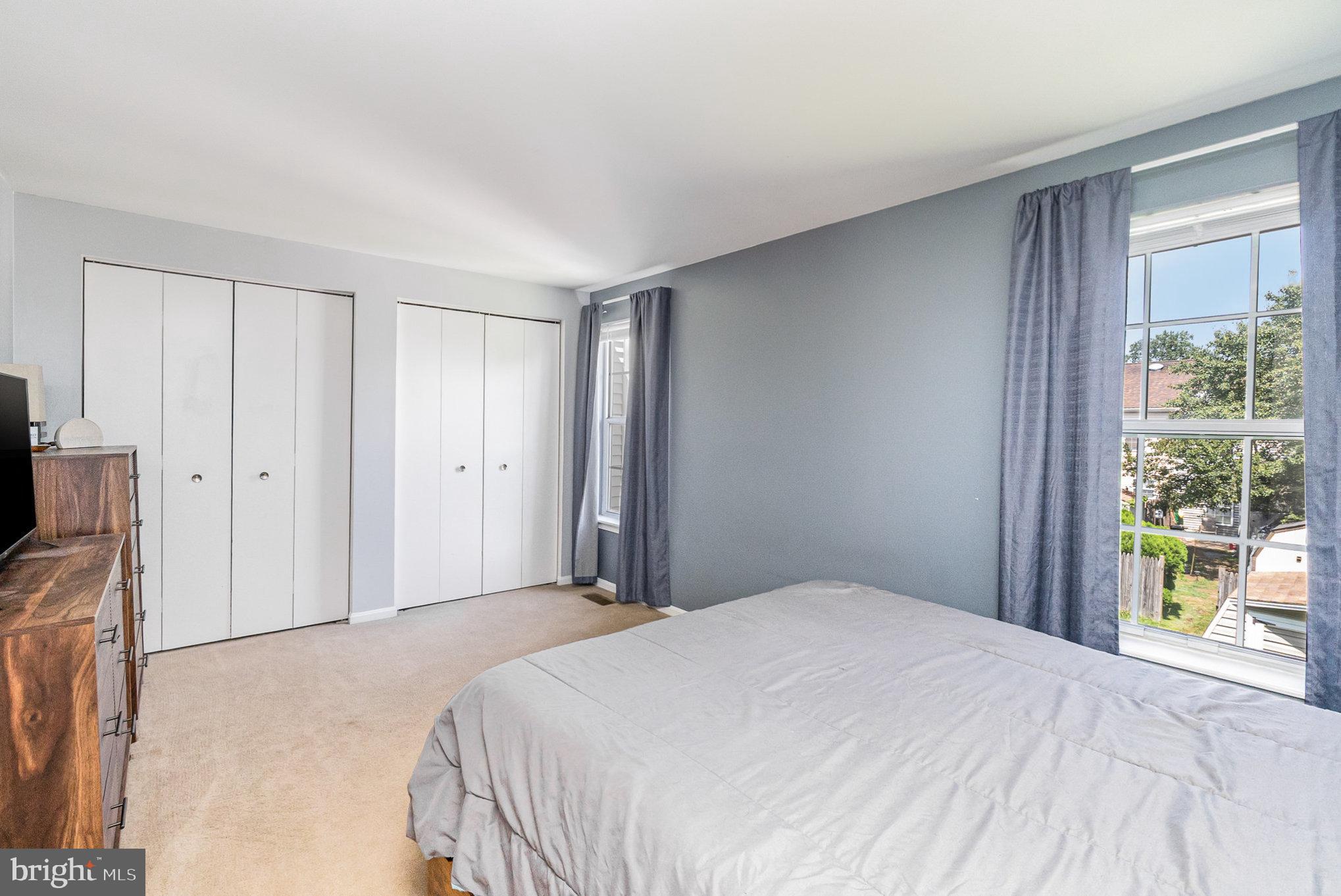 1213 Brice Square Belcamp, MD 21017 - Photo 15 of 23 a bedroom with a bed and a flat tv screen next to a window