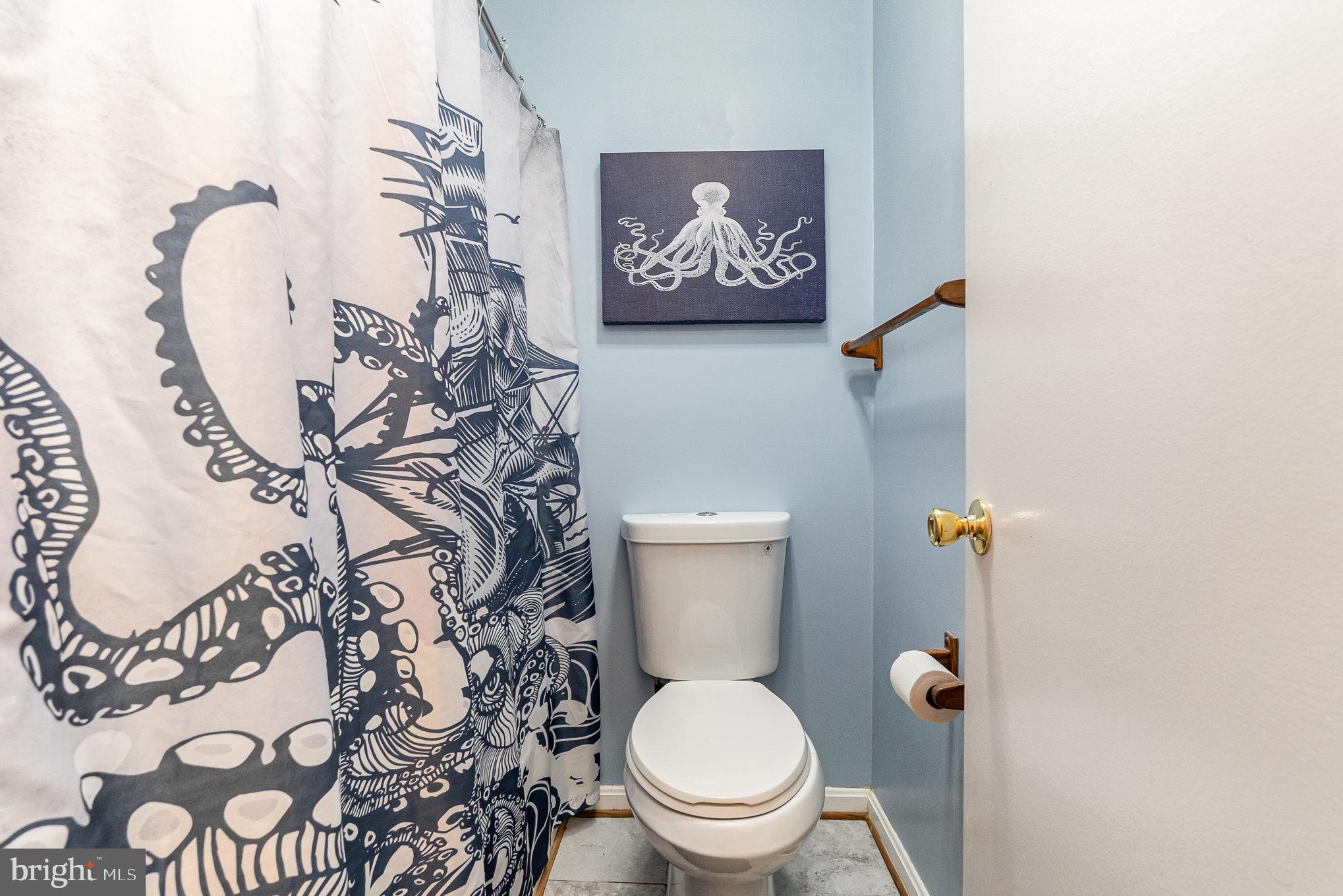 1213 Brice Square Belcamp, MD 21017 - Photo 20 of 23 a white toilet sitting next to a shower curtain