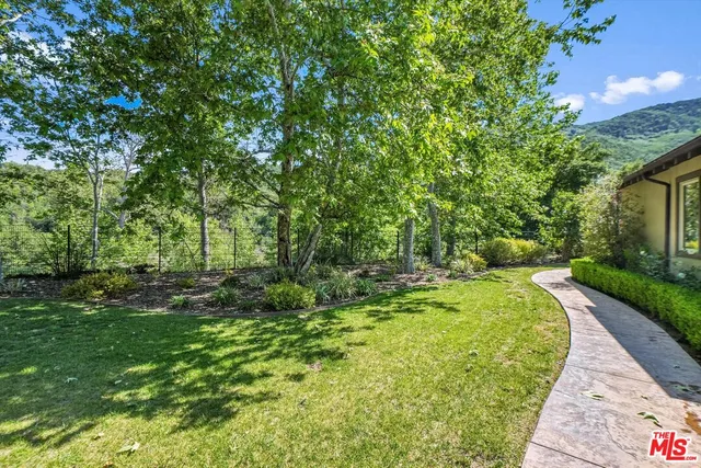 a view of a house with pool and chairs