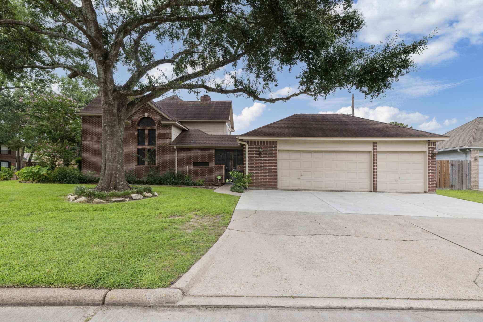 5802 Ashmere Lane Spring, TX 77379 - Photo 17 of 19 a front view of a house with a garden and trees