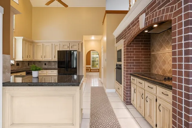 a bathroom with a granite countertop sink a toilet and a mirror