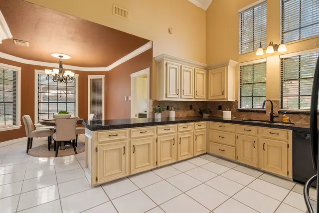 a large white kitchen with a large window