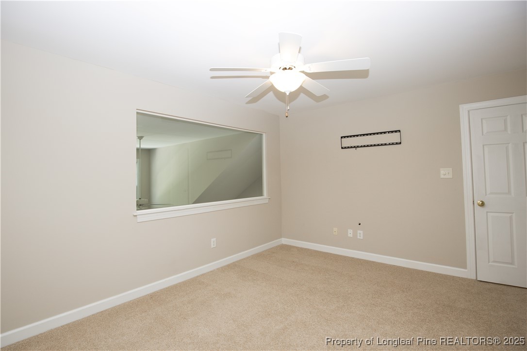 175 Knoll Road Southern Pines, NC 28387 - Photo 36 of 50 an empty room with a window and a fan