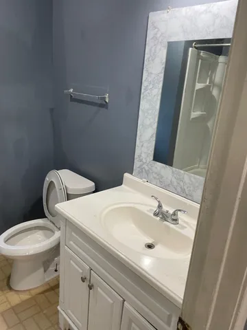a bathroom with a sink mirror and toilet