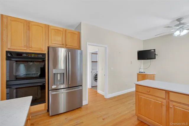 a kitchen with stainless steel appliances a refrigerator and a stove top oven