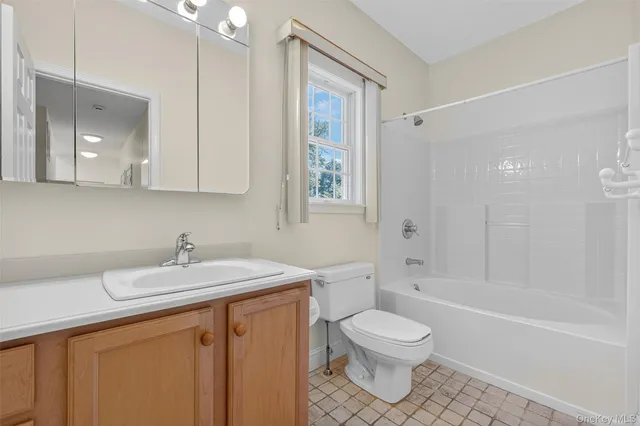 a bathroom with a sink toilet a mirror and shower