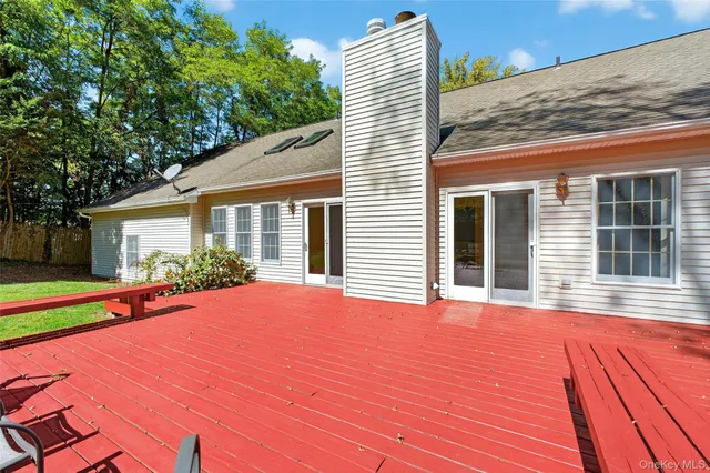 a front view of a house with a yard and potted plants