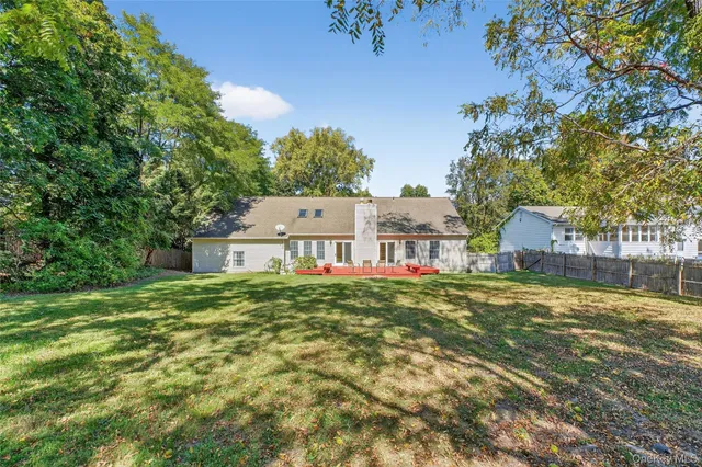 a view of a big house with a big yard and large tree