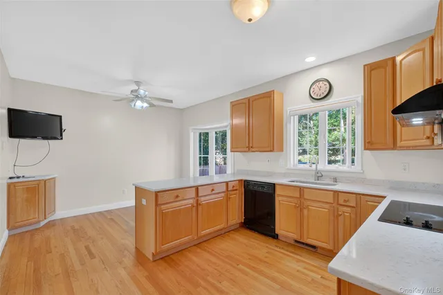 a kitchen with a sink cabinets and window