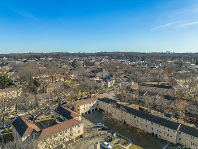 an aerial view of a residential houses with city view