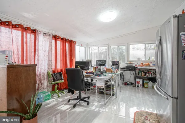 a view of a livingroom with furniture and a window