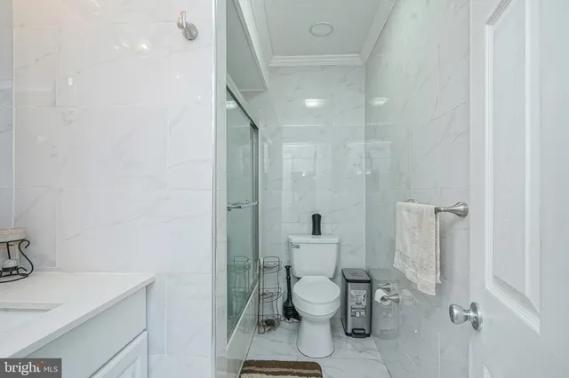 a white toilet sitting next to a bathroom sink