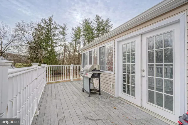 a view of deck with a large window and wooden floor