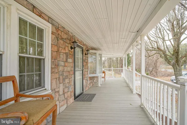 a view of balcony with wooden floor and seating space
