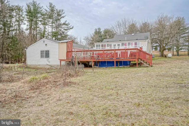 a view of a house with a yard and sitting area