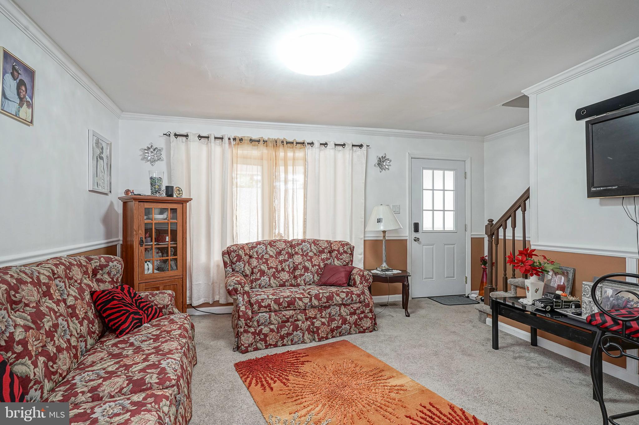 430 Monroeville Road Mullica Hill, NJ 08062 - Photo 4 of 31 a living room with furniture a rug and a flat screen tv