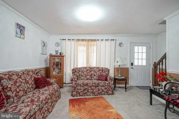 a living room with furniture rug and window