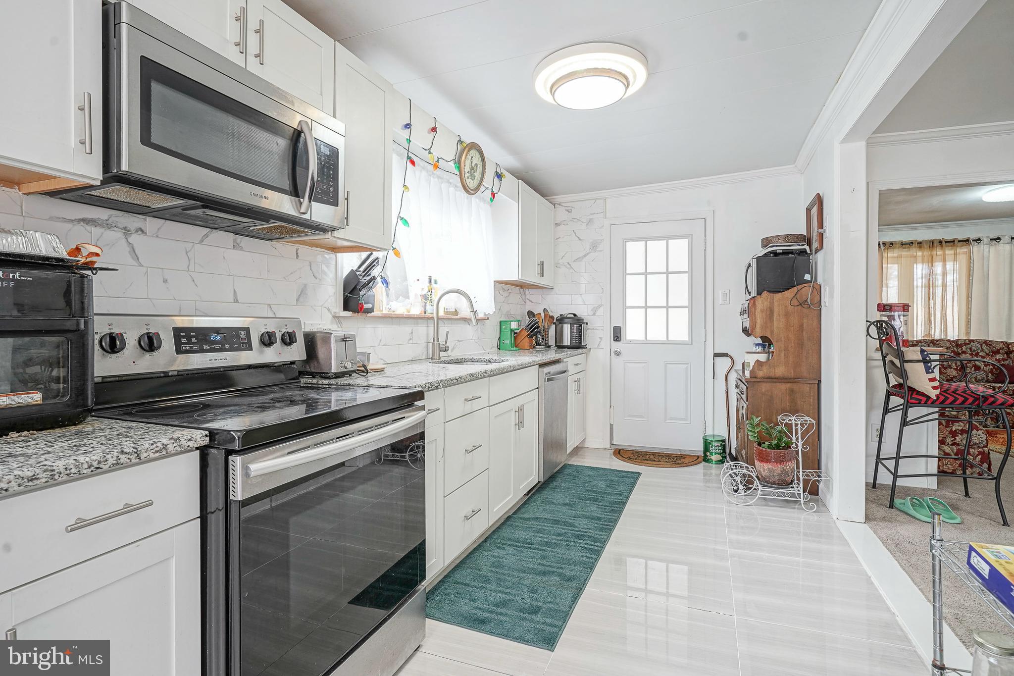 430 Monroeville Road Mullica Hill, NJ 08062 - Photo 10 of 31 a kitchen with stainless steel appliances granite countertop a stove and cabinets