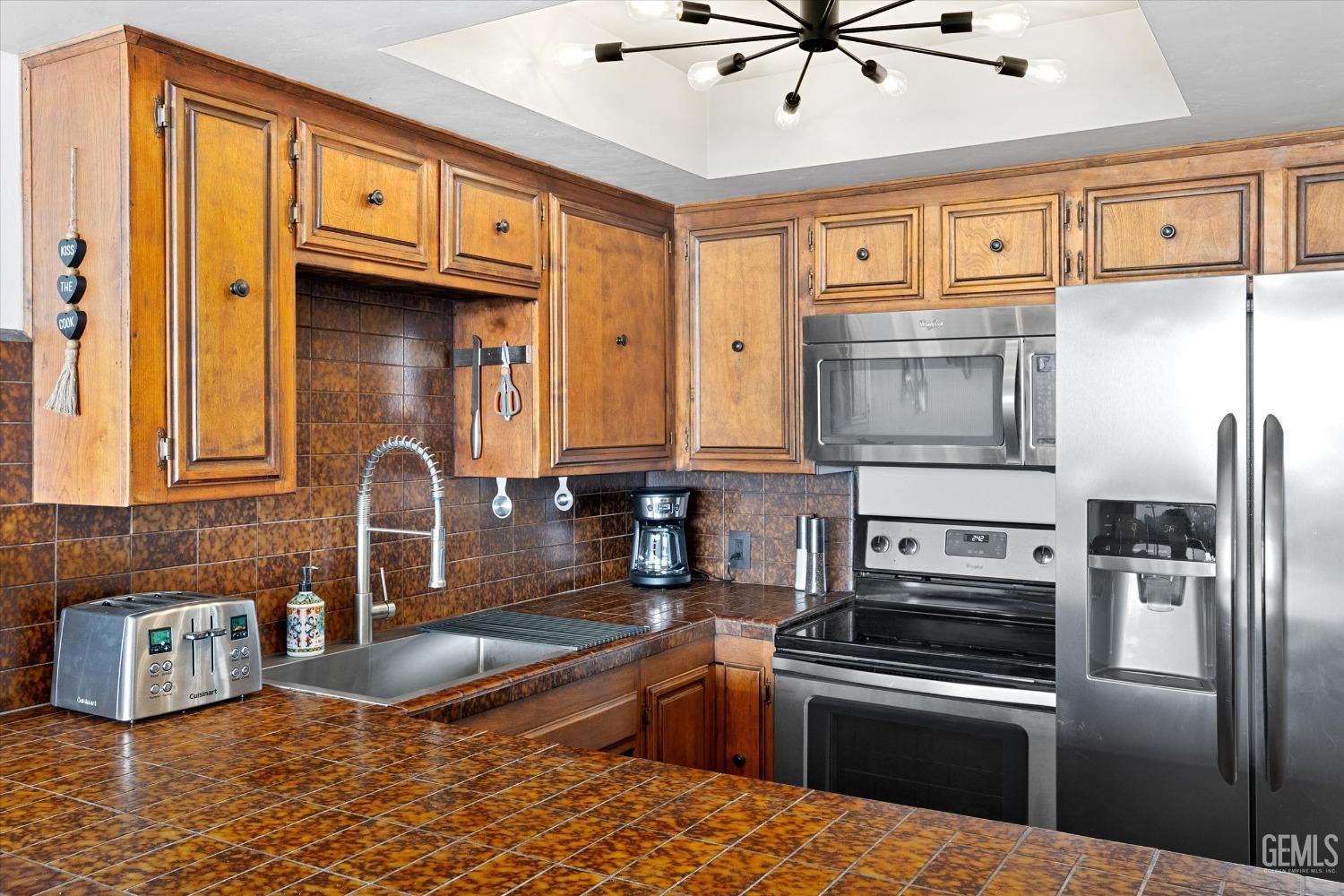 Undisclosed Address Bakersfield, CA 93306 - Photo 24 of 52 a kitchen with stainless steel appliances granite countertop a refrigerator a stove and a sink